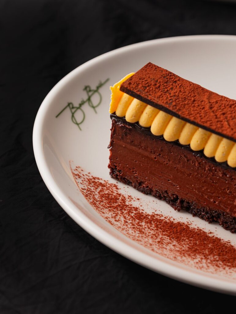 A slice of chocolate torta on a white plate