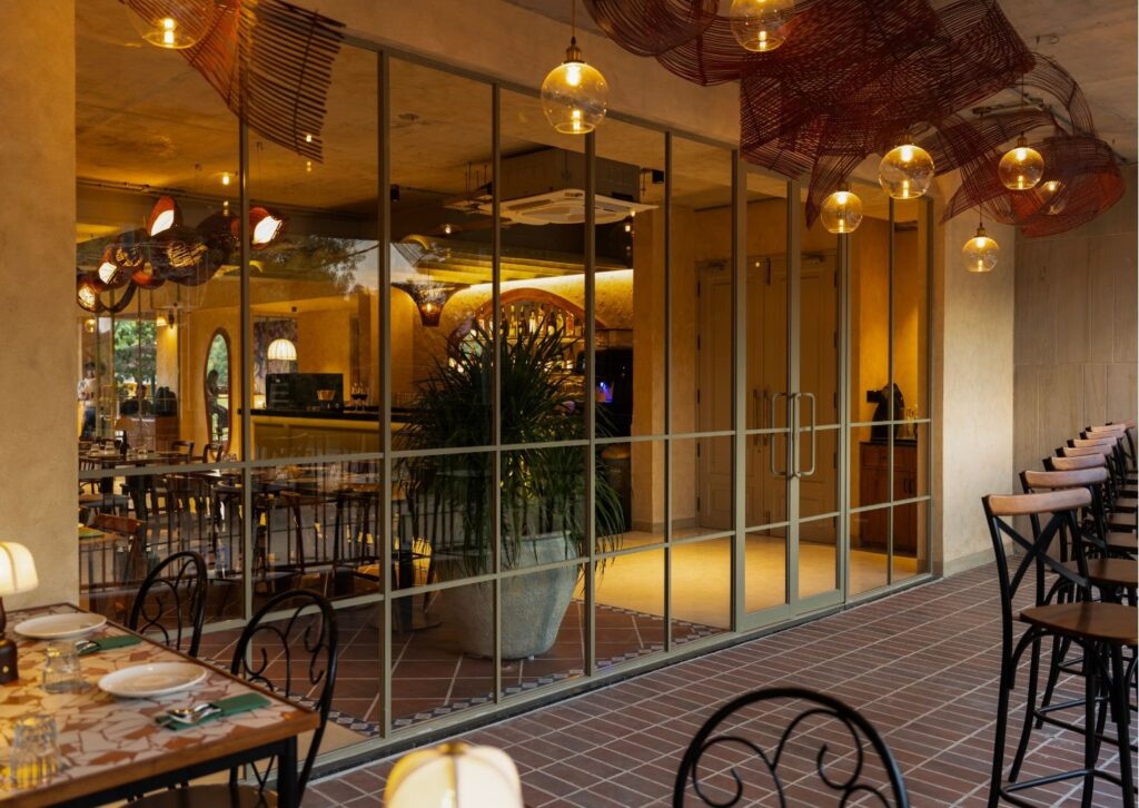 The glass frontage of the osteria in the evening