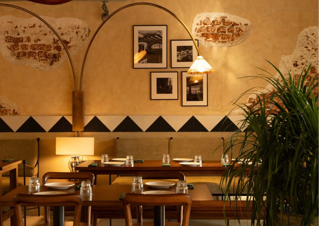 Framed black-and-white photographs above a banquette