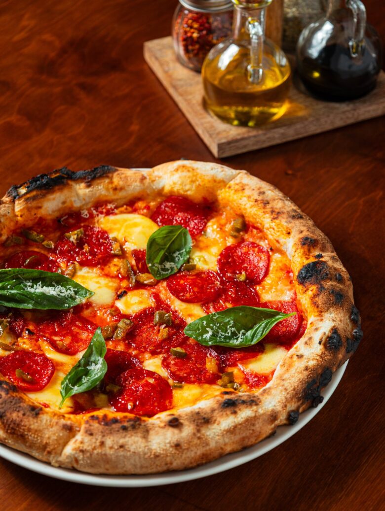 A margherita pizza topped with fresh basil