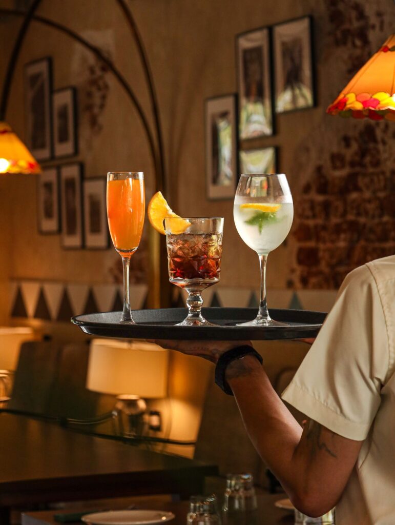 A tray of cocktails carried through the dining room