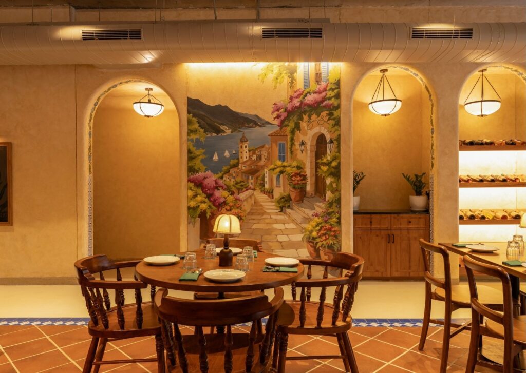 A hand-painted Amalfi coast mural framed by arched alcoves