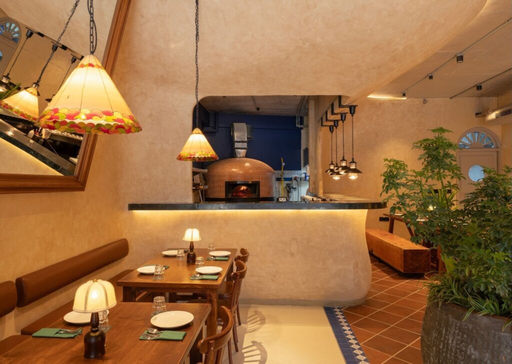 Banquette seating beside the wood-fired oven
