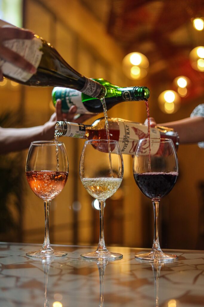 Rosé, white and red wine poured at the bar